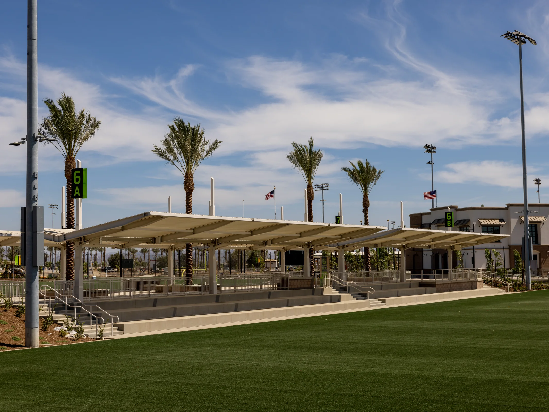 Shaded seating beside a playing field at Ontario Sports Empire