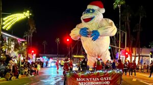 An illuminated character balloon and spectators at a previous Palm Springs Festival of Lights Parade