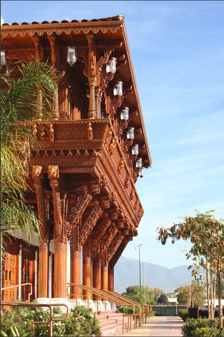 Carved exterior detail and campus walkway at BAPS Los Angeles