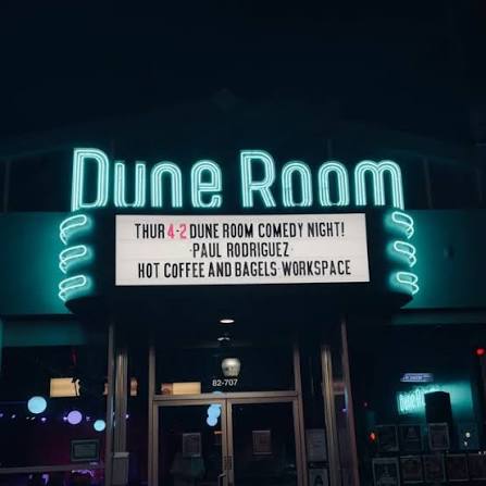 Neon Dune Room sign and entrance in Indio at night