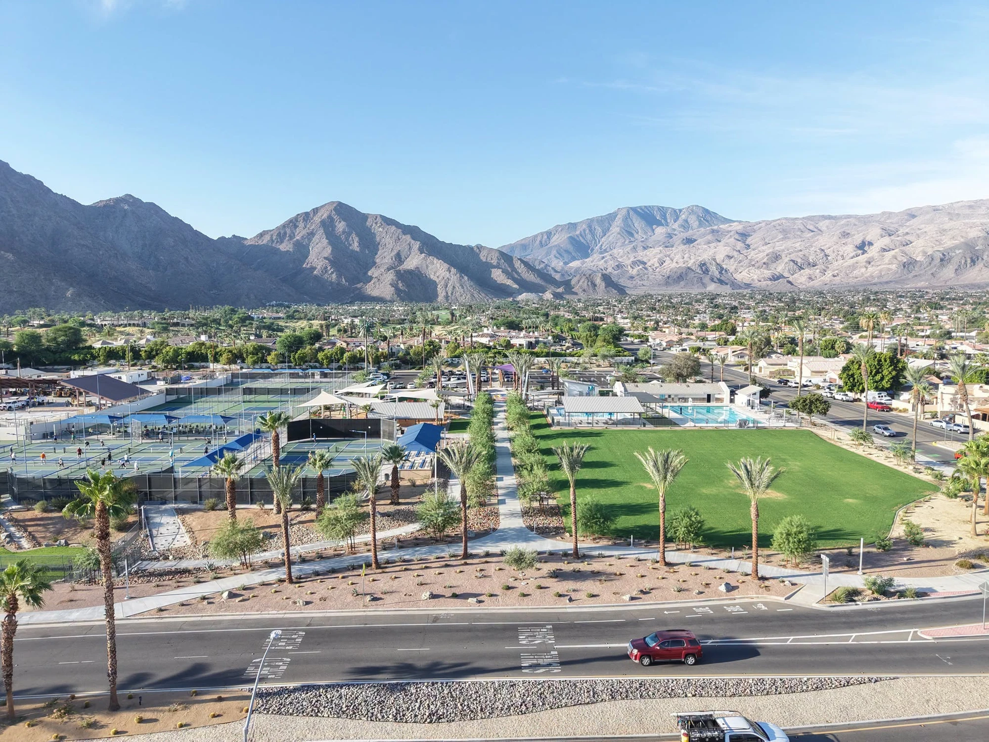 Aerial view across Fritz Burns Park courts, lawn and swimming pool