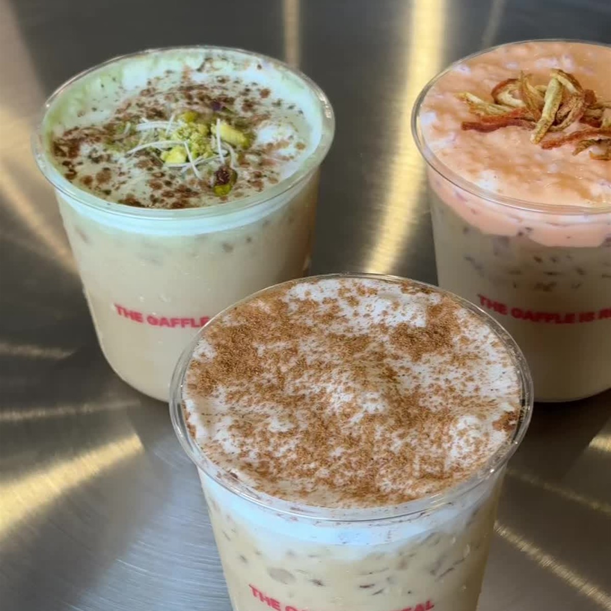 Three cold coffee drinks topped with foam at Gaffle Coffee in Temecula