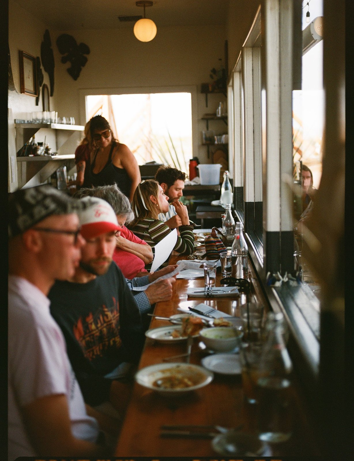 Diners seated beside the windows inside La Copine