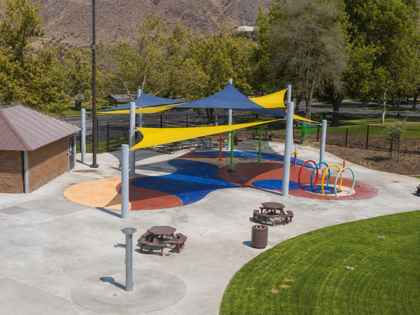 Aerial view of the shaded splash pad at Martin Tudor Splash Park in Fontana