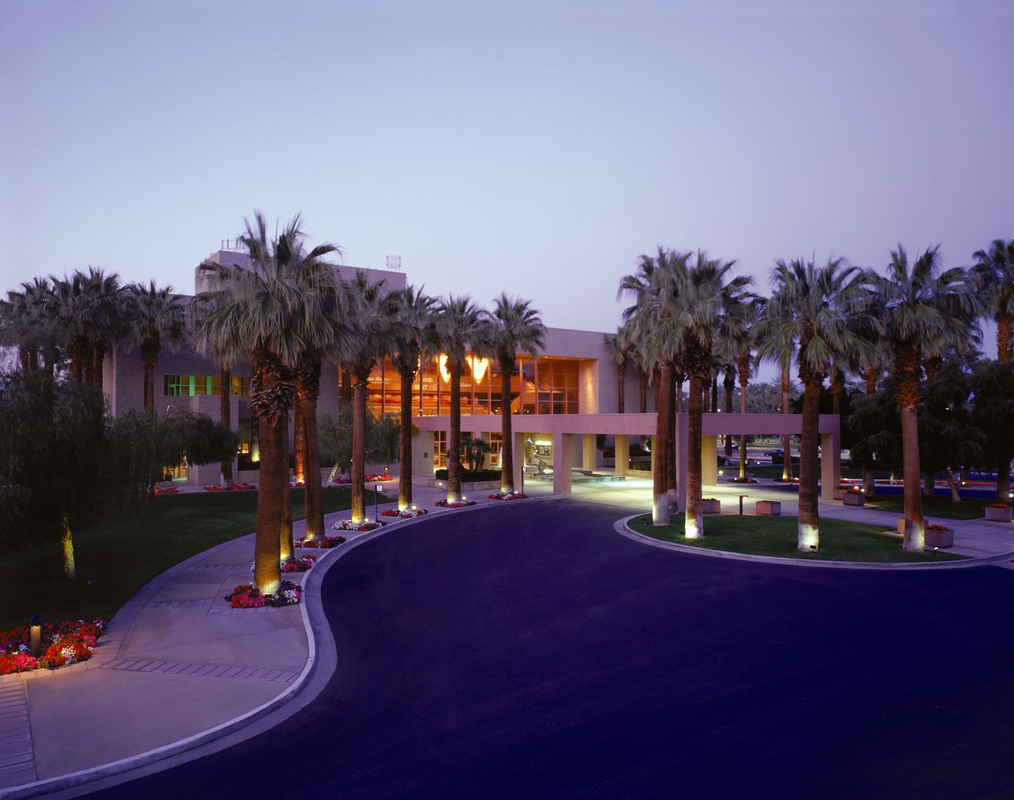 McCallum Theatre entrance and palm-lined drive at dusk in Palm Desert