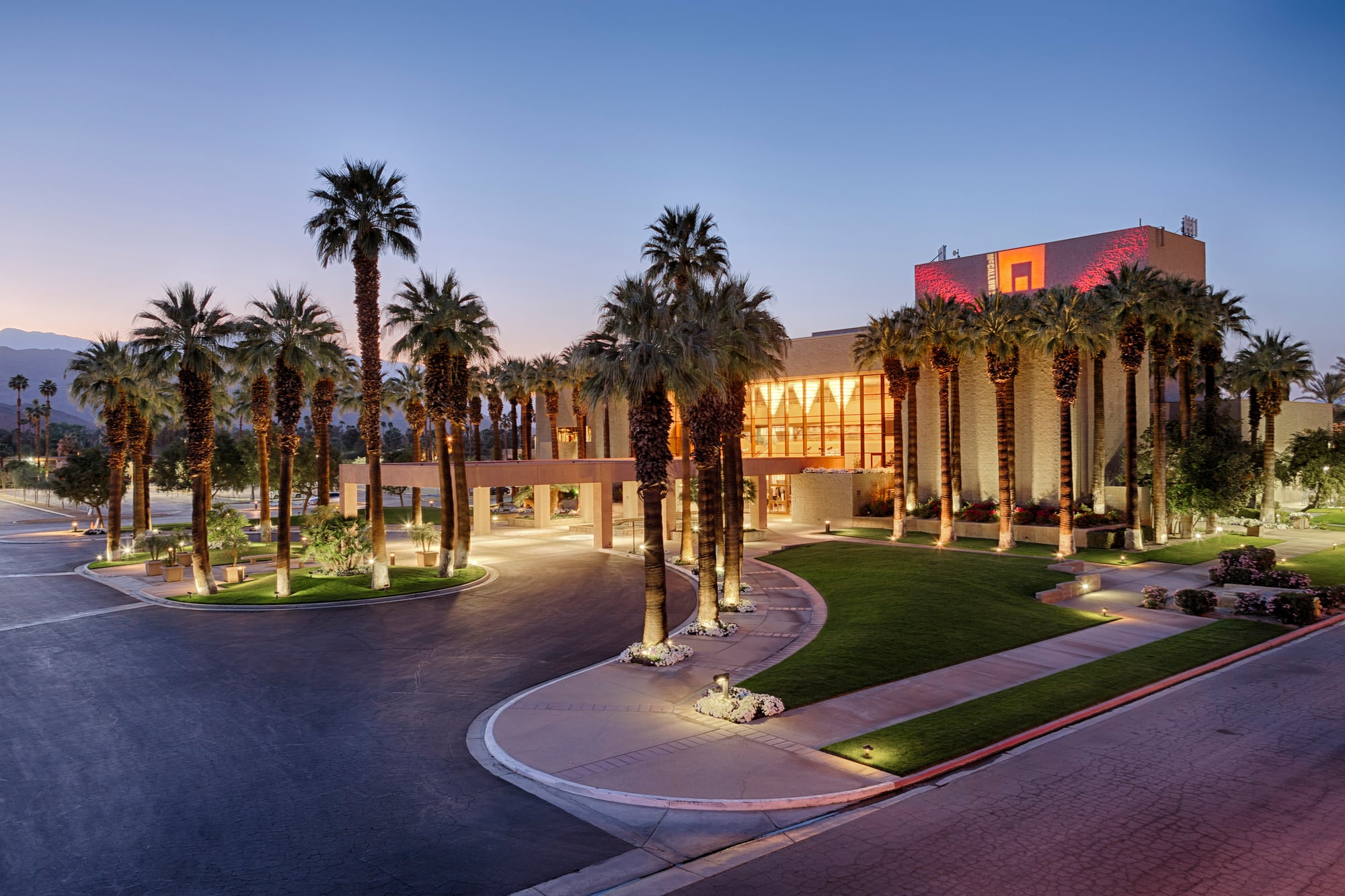 McCallum Theatre exterior, palm trees, and entrance at dusk in Palm Desert