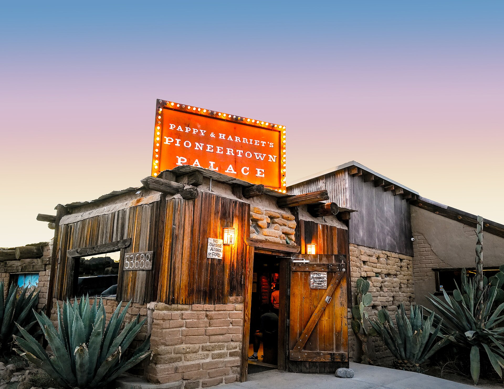 Illuminated exterior and sign at Pappy and Harriet's Pioneertown Palace