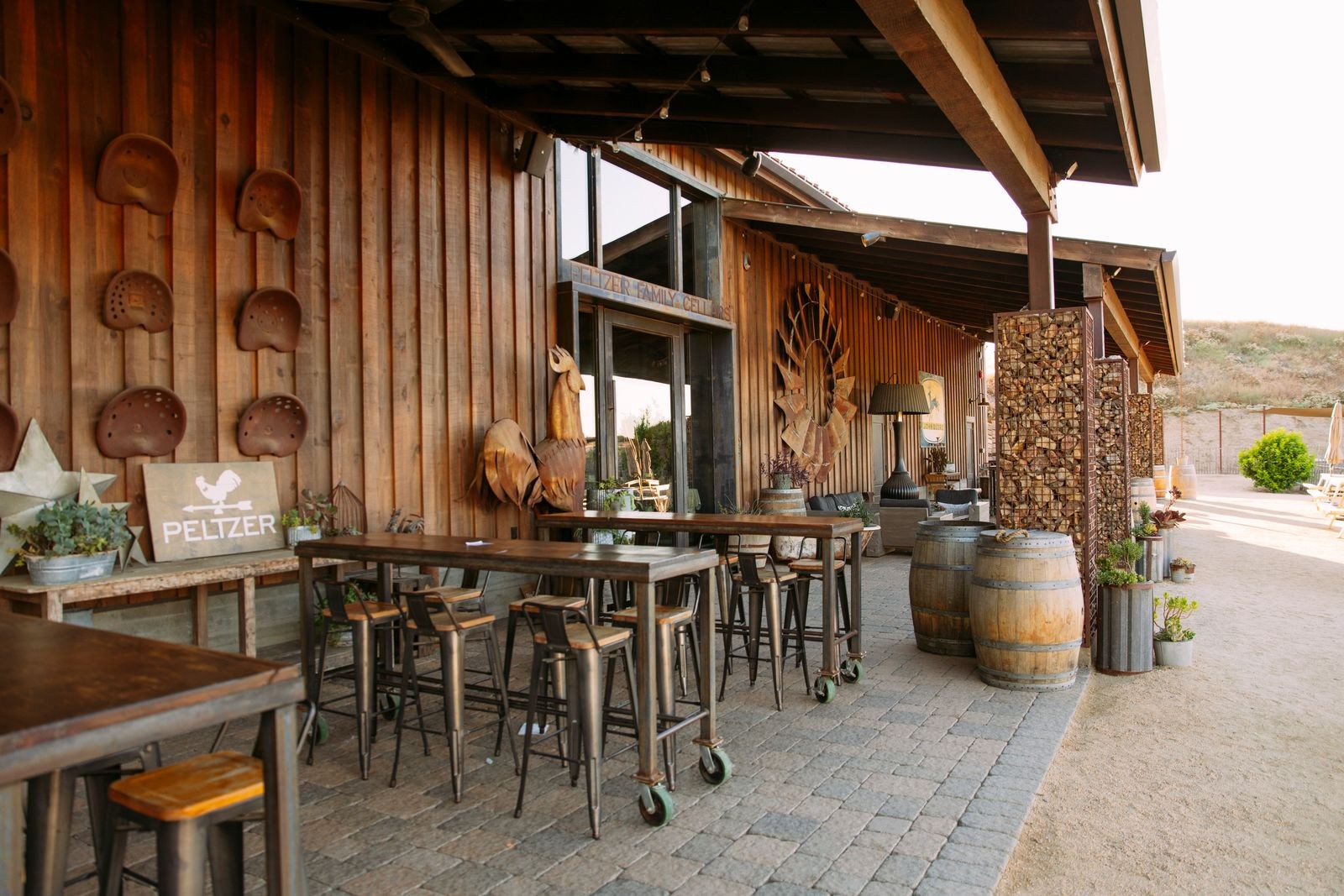 Covered seating and rustic wood details outside the Crush House at Peltzer Winery
