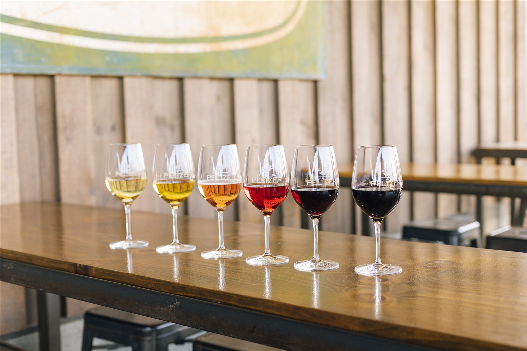 A row of six wine glasses inside Peltzer Winery