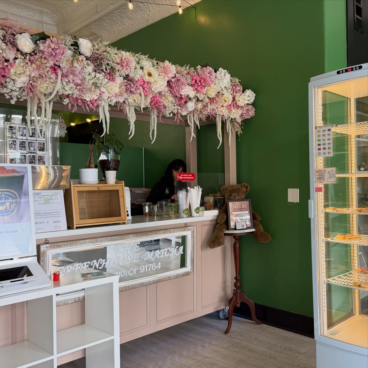 Interior counter with floral decor at The Greenhouse Matcha in Downtown Ontario